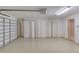 Clean garage features an epoxy floor, garage door and additional storage space at 38 Lake Walden Trl, Ormond Beach, FL 32174
