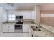Bright kitchen with stainless steel appliances and granite countertops for a modern and appealing look at 38 Lake Walden Trl, Ormond Beach, FL 32174