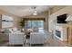 Bright living room featuring a fireplace, ceiling fan, and a sliding glass door with water view at 38 Lake Walden Trl, Ormond Beach, FL 32174