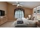 Bright main bedroom with a ceiling fan, and a large window covered by decorative drapes at 38 Lake Walden Trl, Ormond Beach, FL 32174