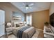 Comfortable primary bedroom with neutral colors, a ceiling fan, and a window for natural light at 38 Lake Walden Trl, Ormond Beach, FL 32174