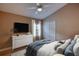 Comfortable primary bedroom with neutral colors, a ceiling fan, and a window for natural light at 38 Lake Walden Trl, Ormond Beach, FL 32174