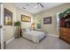 Cozy bedroom featuring a patterned bed, tiled floors, natural light, and decorative wall art at 3817 Islamorada Dr, Ormond Beach, FL 32176
