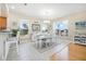 Bright dining room features tile flooring, natural light from windows, seating for six, and coastal decor at 3817 Islamorada Dr, Ormond Beach, FL 32176