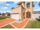 Close up of charming home featuring a red brick driveway, attached garage, and welcoming front entrance at 3817 Islamorada Dr, Ormond Beach, FL 32176