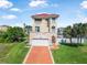 Inviting two-story home with a red tile roof, manicured lawn, and a driveway leading to an attached garage at 3817 Islamorada Dr, Ormond Beach, FL 32176