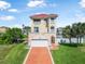 Stunning three-story home with a red tile roof, spacious garage, and lush green lawn at 3817 Islamorada Dr, Ormond Beach, FL 32176