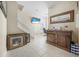 Bright hall features stairway, tile flooring, television, desk, and natural light from window at 3817 Islamorada Dr, Ormond Beach, FL 32176