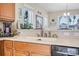 Sunlit kitchen featuring a stainless steel faucet, modern appliances, and charming decor at 3817 Islamorada Dr, Ormond Beach, FL 32176