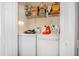 Efficient laundry space with a modern white washer and dryer, complemented by practical shelving for storage at 3817 Islamorada Dr, Ormond Beach, FL 32176