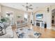 Spacious living room features hardwood flooring, coastal decor, television, and natural light from multiple windows at 3817 Islamorada Dr, Ormond Beach, FL 32176