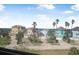 Stunning view of beautiful neighborhood homes with tropical landscaping and the ocean as seen from the home's window at 3817 Islamorada Dr, Ormond Beach, FL 32176