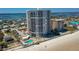 Aerial view of a beachfront condo building showcasing pool, parking, and beach access at 3855 S Atlantic Ave # 405, Daytona Beach, FL 32118