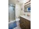 Bathroom featuring a glass shower, neutral colored tile, and a decorative vanity at 3855 S Atlantic Ave # 405, Daytona Beach, FL 32118