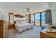 Serene bedroom featuring a sliding glass door to the balcony with ocean views, plus coastal-themed decor at 3855 S Atlantic Ave # 405, Daytona Beach, FL 32118