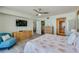 Comfortable bedroom with ceiling fan, dresser, and view into the dining area and bathroom at 3855 S Atlantic Ave # 405, Daytona Beach, FL 32118