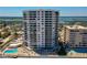Exterior of tall beachfront condo building with ocean views and private parking lot at 3855 S Atlantic Ave # 405, Daytona Beach, FL 32118