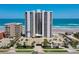 Exterior view of a condo building with private parking, pool and beach access at 3855 S Atlantic Ave # 405, Daytona Beach, FL 32118