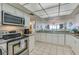 Open kitchen with granite countertops and stainless appliances connected to the dining area and with ocean views at 3855 S Atlantic Ave # 405, Daytona Beach, FL 32118