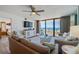 Relaxing living room with ocean view, comfortable sofas, and a ceiling fan for added comfort at 3855 S Atlantic Ave # 405, Daytona Beach, FL 32118