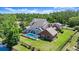This aerial view displays the pool, lawn and surrounding landscape of the property at 4 Huntsman Look, Ormond Beach, FL 32174