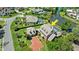 An aerial view shows the property's pool, pond, and brick driveway at 4 Huntsman Look, Ormond Beach, FL 32174