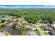 An elevated aerial view highlights the property's pool, pond, and landscaping at 4 Huntsman Look, Ormond Beach, FL 32174