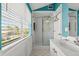 Bathroom with glass shower, tiled floors, and window at 4 Huntsman Look, Ormond Beach, FL 32174