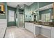 Bathroom featuring a double sink vanity, glass-enclosed shower, and ample natural light from multiple windows at 4 Huntsman Look, Ormond Beach, FL 32174