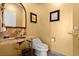 A half bathroom with a beautiful marble sink and marble accent wall with light yellow walls at 4 Huntsman Look, Ormond Beach, FL 32174