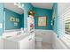 Bathroom featuring blue walls, white wainscotting and sink at 4 Huntsman Look, Ormond Beach, FL 32174