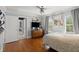 Cozy bedroom with hardwood floors, natural light from windows, and a ceiling fan at 4 Huntsman Look, Ormond Beach, FL 32174