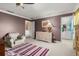 Bright bedroom with neutral carpet, an area rug, and dresser near an ensuite bathroom and doorway at 4 Huntsman Look, Ormond Beach, FL 32174