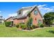 Charming brick home with lush landscaping and vibrant green shutters at 4 Huntsman Look, Ormond Beach, FL 32174