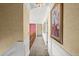 Inviting hallway with wainscoting, neutral carpeting, artwork, and access to various rooms at 4 Huntsman Look, Ormond Beach, FL 32174