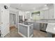 Modern kitchen featuring stainless steel appliances, a kitchen island, and elegant white and gray cabinetry at 4 Huntsman Look, Ormond Beach, FL 32174