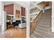 Open-concept living space highlighting the staircase, fireplace, piano, and seamless flow throughout the home at 4 Huntsman Look, Ormond Beach, FL 32174