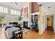 Bright living area with a fireplace, piano, and large windows offering an abundance of natural light at 4 Huntsman Look, Ormond Beach, FL 32174