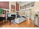 Spacious living room featuring high ceilings, a fireplace, and a grand piano for elegant entertaining at 4 Huntsman Look, Ormond Beach, FL 32174