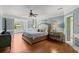 A spacious main bedroom with beautiful trimwork, a ceiling fan, and views to an outdoor space at 4 Huntsman Look, Ormond Beach, FL 32174