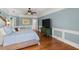A main bedroom featuring a comfortable bed, ceiling fan, and light blue walls accented with white trim work at 4 Huntsman Look, Ormond Beach, FL 32174