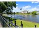 A tranquil water view shows a beautifully landscaped home across the pond at 4 Huntsman Look, Ormond Beach, FL 32174