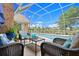 Screened-in outdoor living space with comfortable seating and a view of the refreshing in-ground swimming pool at 4 Huntsman Look, Ormond Beach, FL 32174