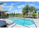 Inviting screened pool offers a refreshing escape with scenic views of the well-manicured backyard at 4 Huntsman Look, Ormond Beach, FL 32174