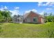 A brick house features an enclosed screened in pool and a spacious backyard at 4 Huntsman Look, Ormond Beach, FL 32174