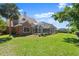 A red brick house has an enclosed pool area and a well maintained lawn at 4 Huntsman Look, Ormond Beach, FL 32174
