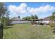 Spacious backyard with a covered patio, lush green grass, and a white privacy fence at 417 Jeffers St, Deltona, FL 32725