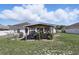 Green backyard featuring a gazebo, a grill, and a well-maintained lawn at 417 Jeffers St, Deltona, FL 32725