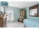 Bright bedroom with a desk, a mirror, and soft blue walls at 417 Jeffers St, Deltona, FL 32725