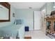 Bright bedroom with tile floors, sky blue walls, and a cozy twin bed with blue accents at 417 Jeffers St, Deltona, FL 32725